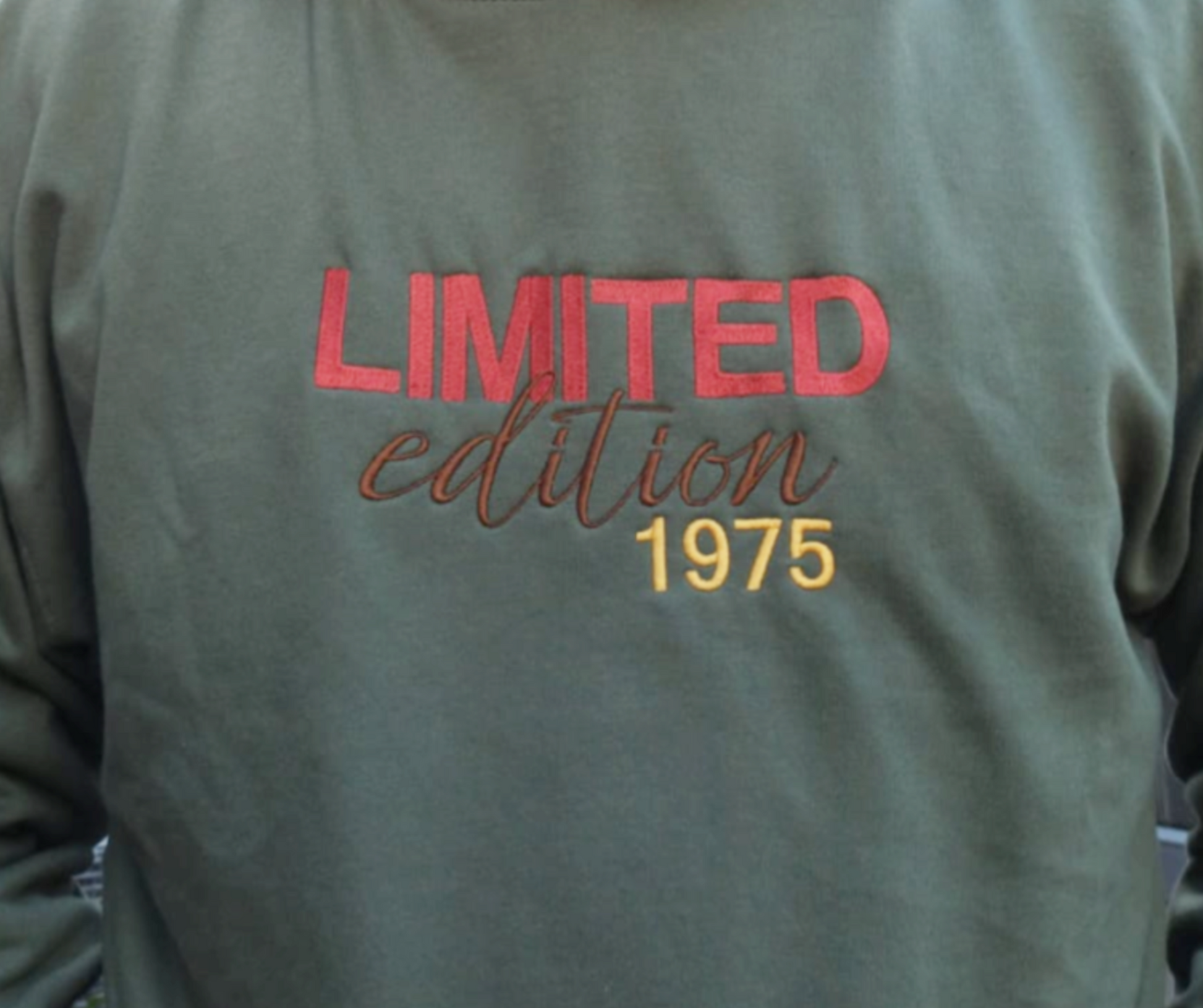 Earthy Green Sweatshirt with 'LIMITED edition 1975' text in red, brown and yellow.
